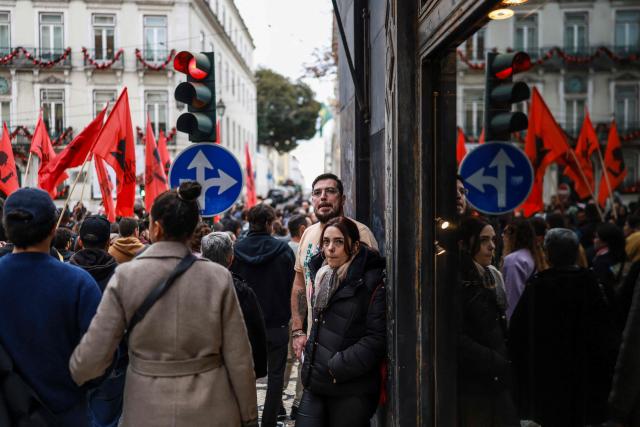 Protestors take part in a demonstration during a general strike against a labour code reform project, called by the country's two main unions in Lisbon on December 11, 2025. Widespread disruption hit Portuguese air travel and trains, hospitals and schools as the unions called the biggest nationwide strike action for more than a decade, protesting against a draft law aiming to simplify firing procedures, extend the length of fixed-term contracts and expand the minimum services required during a strike. (Photo by PATRICIA DE MELO MOREIRA / AFP)