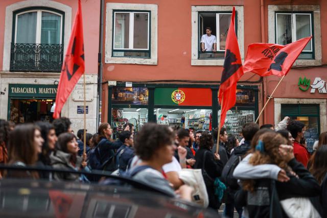Protestors demonstrate during a general strike against a labour code reform project, called by the country's two main unions in Lisbon on December 11, 2025. Widespread disruption hit Portuguese air travel and trains, hospitals and schools as the unions called the biggest nationwide strike action for more than a decade, protesting against a draft law aiming to simplify firing procedures, extend the length of fixed-term contracts and expand the minimum services required during a strike. (Photo by PATRICIA DE MELO MOREIRA / AFP)