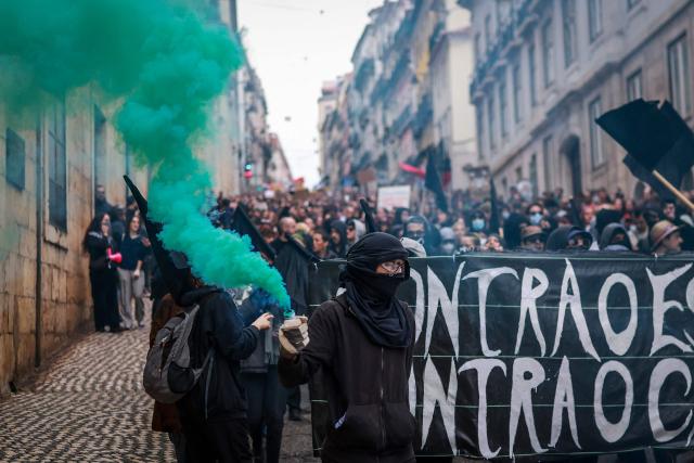 Protestors take part in a demonstration during a general strike against a labour code reform project, called by the country's two main unions in Lisbon on December 11, 2025. Widespread disruption hit Portuguese air travel and trains, hospitals and schools as the unions called the biggest nationwide strike action for more than a decade, protesting against a draft law aiming to simplify firing procedures, extend the length of fixed-term contracts and expand the minimum services required during a strike. (Photo by PATRICIA DE MELO MOREIRA / AFP)