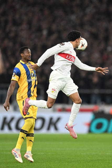 Stuttgart's Portuguese forward #08 Tiago Tomas jumps for the ball against Maccabi Tel Aviv's Guinean defender #05 Mohamed Aly Camara during the UEFA Europa League football match between VfB Stuttgart and Maccabi Tel Aviv in Stuttgart, southern Germany, on December 11, 2025. (Photo by THOMAS KIENZLE / AFP)