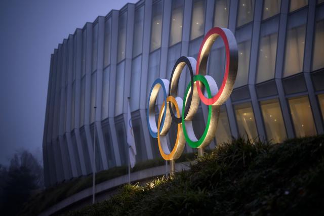 (FILES) This photograph shows the Olympics Rings at the entrance of the Olympic House in Lausanne, on December 9, 2025. The International Olympic Committee on December 11, 2025, urged sports bodies to fully reintegrate Russian and Belarusian athletes into junior competitions and allow them to compete with their national flag and anthem. (Photo by Fabrice COFFRINI / AFP)