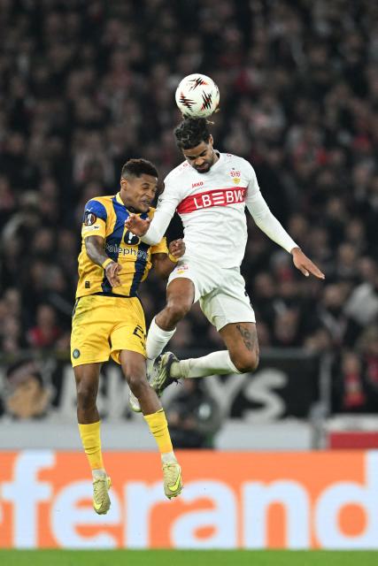 Maccabi Tel Aviv's Cape Verdean forward #29 Helio Varela and Stuttgart's French defender #22 Lorenz Assignon vie for the ball during the UEFA Europa League football match between VfB Stuttgart and Maccabi Tel Aviv in Stuttgart, southern Germany, on December 11, 2025. (Photo by THOMAS KIENZLE / AFP)