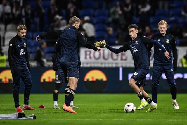 Go Ahead Eagles players warm up ahead of the UEFA Europa League, league phase, football match between Olympique Lyonnais (OL) and Go Ahead Eagles at the Groupama Stadium in Decines-Charpieu, central-eastern France, on December 11, 2025. (Photo by JEFF PACHOUD / AFP)