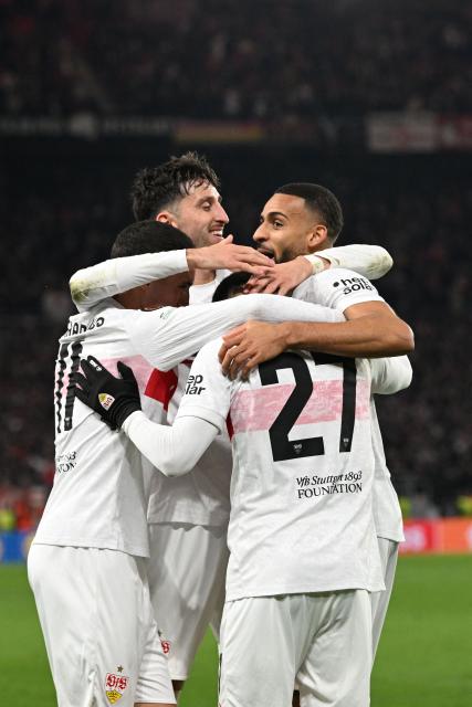 Stuttgart's German defender #04 Josha Vagnoman (R) celebrates with his team mates after scoring his team's 4:0 during the UEFA Europa League football match between VfB Stuttgart and Maccabi Tel Aviv in Stuttgart, southern Germany, on December 11, 2025. (Photo by THOMAS KIENZLE / AFP)