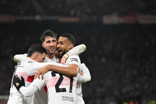 Stuttgart's German defender #04 Josha Vagnoman (R) celebrates with his team mates after scoring his team's 4:0 during the UEFA Europa League football match between VfB Stuttgart and Maccabi Tel Aviv in Stuttgart, southern Germany, on December 11, 2025. (Photo by THOMAS KIENZLE / AFP)
