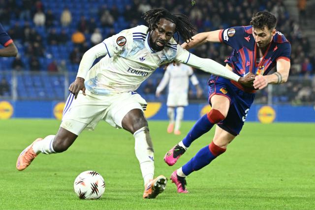 Aston Villa's Ivorian forward #29 Evann Guessand (C) fights for the ball with Basel's Swiss midfielder #31 Dominik Schmid (R) during the UEFA Europa League, league phase, football match between FC Basel and Aston Villa at the St Jakob-Park stadium, in Basel, on December 11, 2025. (Photo by SEBASTIEN BOZON / AFP)
