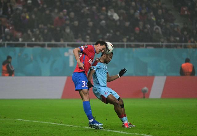 FCSB's Montenegrin defender #33 Risto Radunovic (L) and Feyenoord's Dutch midfielder #08 Quinten Timber vie for the ball during the UEFA Europa League first round - day 6 football match between FC FCSB Bucharest and Feyenoord in Bucharest, Romania, on December 11, 2025. (Photo by Daniel MIHAILESCU / AFP)