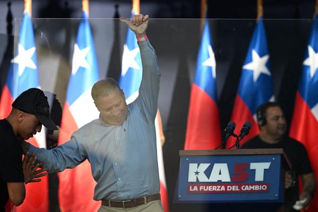 Workers install bulletproof glass to protect Chilean presidential candidate Jose Antonio Kast of the Republican Party before his closing campaign rally in Temuco, Chile, on December 11, 2025. The second round of the Chilean presidential election on December 14 will pit two candidates against each other who are diametrically opposed: Jeannette Jara, the representative of a broad left-wing coalition with modest origins, and the far-right leader Jose Antonio Kast, an ultraconservative Catholic determined to massively expel undocumented migrants. (Photo by EITAN ABRAMOVICH / AFP)