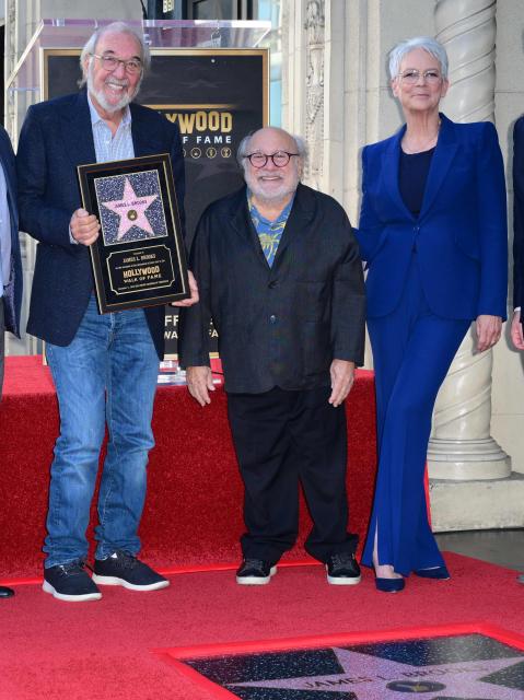 (L/R) US director, writer and producer James L. Brooks poses alongside US actor Danny DeVito and US actress Jamie Lee Curtis during the unveiling ceremony of his star at the Hollywood Walk of Fame in Hollywood, California, on December 11, 2025. (Photo by Frederic J. BROWN / AFP)