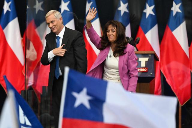 Chile's presidential candidate Jose Antonio Kast of the Republican Party gestures next to his wife Maria Adriasola during his closing campaign rally in Temuco, Chile on December 11, 2025. The second round of the Chilean presidential election on December 14 will pit two candidates against each other who are diametrically opposed: Jeannette Jara, the representative of a broad left-wing coalition with modest origins, and the far-right leader Jose Antonio Kast, an ultraconservative Catholic determined to massively expel undocumented migrants. (Photo by Eitan ABRAMOVICH / AFP)