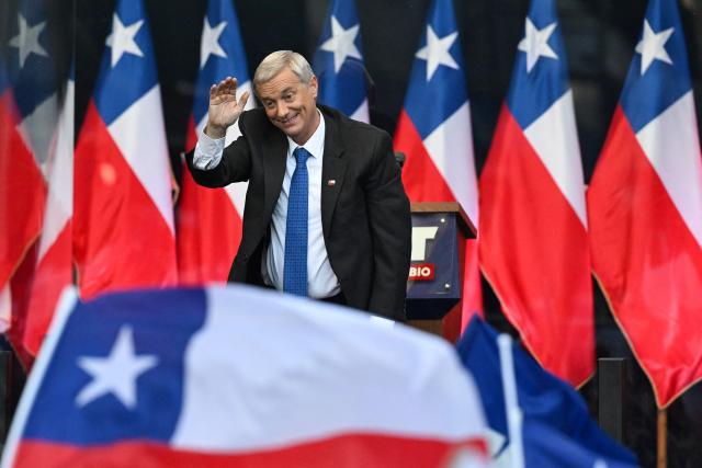 Chile's presidential candidate Jose Antonio Kast of the Republican Party waves to supporters during his closing campaign rally in Temuco, Chile on December 11, 2025. The second round of the Chilean presidential election on December 14 will pit two candidates against each other who are diametrically opposed: Jeannette Jara, the representative of a broad left-wing coalition with modest origins, and the far-right leader Jose Antonio Kast, an ultraconservative Catholic determined to massively expel undocumented migrants. (Photo by Eitan ABRAMOVICH / AFP)