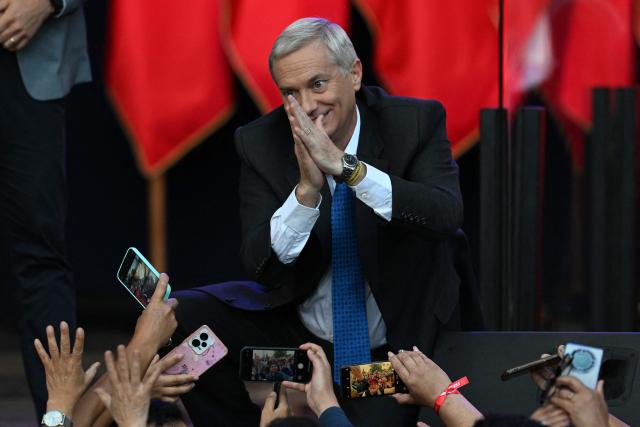 Chile's presidential candidate Jose Antonio Kast of the Republican Party gestures during his closing campaign rally in Temuco, Chile on December 11, 2025. The second round of the Chilean presidential election on December 14 will pit two candidates against each other who are diametrically opposed: Jeannette Jara, the representative of a broad left-wing coalition with modest origins, and the far-right leader Jose Antonio Kast, an ultraconservative Catholic determined to massively expel undocumented migrants. (Photo by EITAN ABRAMOVICH / AFP)