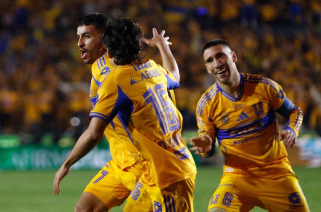Tigres' Argentine forward #07 Angel Correa (L) celebrates after scoring the opening goal with teammates midfielder #16 Diego Lainez and Tigres' Uruguayan midfielder #08 Fernando Gorriaran during the Liga MX Apertura final first leg football match between Tigres and Toluca at the UANL University Stadium in San Nicolas de los Garza, Nuevo Leon State, Mexico on December 11, 2025. (Photo by Julio Cesar AGUILAR / AFP)