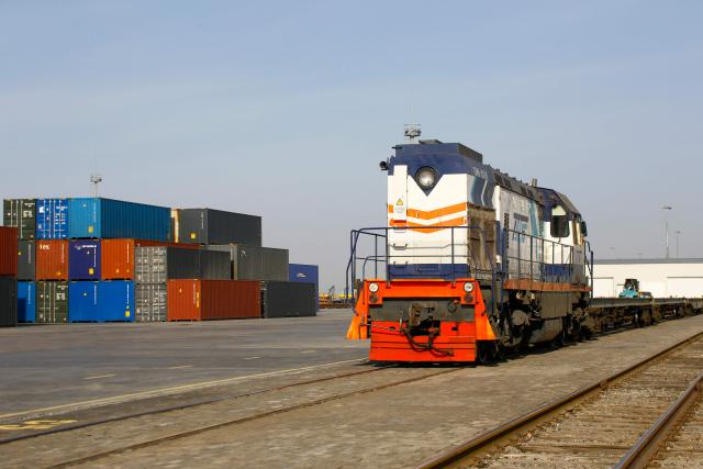 A locomotive moves with freight platforms at the cargo terminal of the railway station of Dostyk at the Kazakh-Chinese border, a key hub for trade between China and Europe through Central Asia, on November 19, 2025. (Photo by Ruslan PRYANIKOV / AFP)