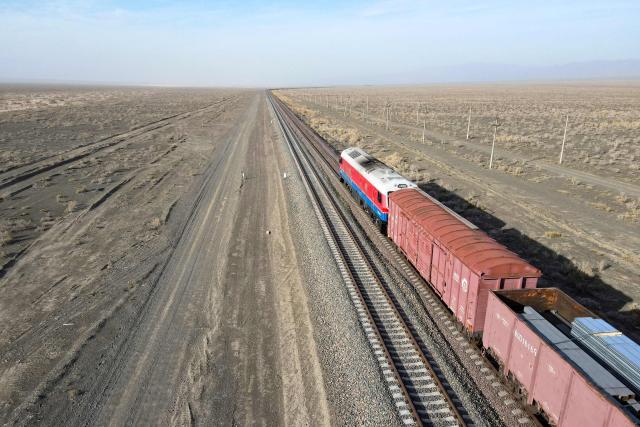 A freight train moves in the steppe near the railway station of Dostyk at the Kazakh-Chinese border, a key hub for trade between China and Europe through Central Asia, on November 19, 2025. (Photo by Ruslan PRYANIKOV / AFP)