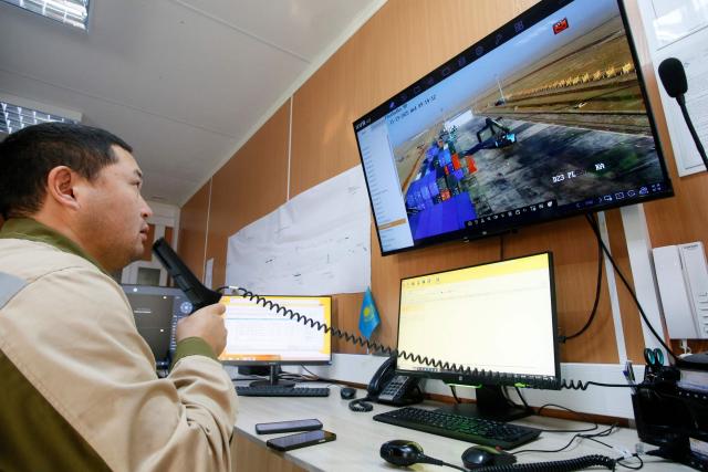 An employee video-controls operations at the cargo terminal of the railway station of Dostyk at the Kazakh-Chinese border, a key hub for trade between China and Europe through Central Asia, on November 19, 2025. (Photo by Ruslan PRYANIKOV / AFP)