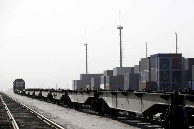 A locomotive moves with freight platforms at the cargo terminal of the railway station of Dostyk at the Kazakh-Chinese border, a key hub for trade between China and Europe through Central Asia, on November 19, 2025. (Photo by Ruslan PRYANIKOV / AFP)