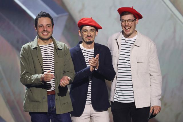 (L-R) Sandfall Interactive's Francois Meurisse, Tom Guillermin and Nicholas Maxson-Francombe, members of the team behind the video game "Clair Obscur: Expedition 33" are seen on stage during The Game Awards at the Peacock Theater in Los Angeles, California, on December 11, 2025. "Clair Obscur: Expedition 33" dominated the annual Game Awards, winning a record of nine categories including best video game of the year. (Photo by Michael Tran / AFP)