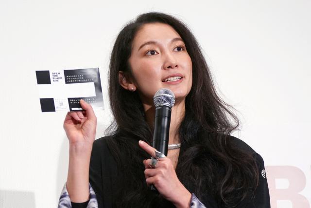 Journalist and Director Shiori Ito speaks during a stage greeting for the first day of the Japanese release of the feature film "Black Box Diaries" in Tokyo on December 12, 2025. (Photo by Kazuhiro NOGI / AFP)