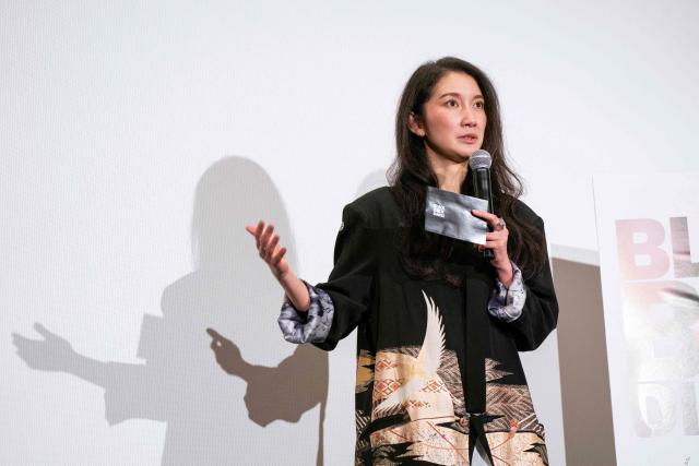 Journalist and Director Shiori Ito speaks during a stage greeting for the first day of the Japanese release of the feature film "Black Box Diaries" in Tokyo on December 12, 2025. (Photo by Kazuhiro NOGI / AFP)