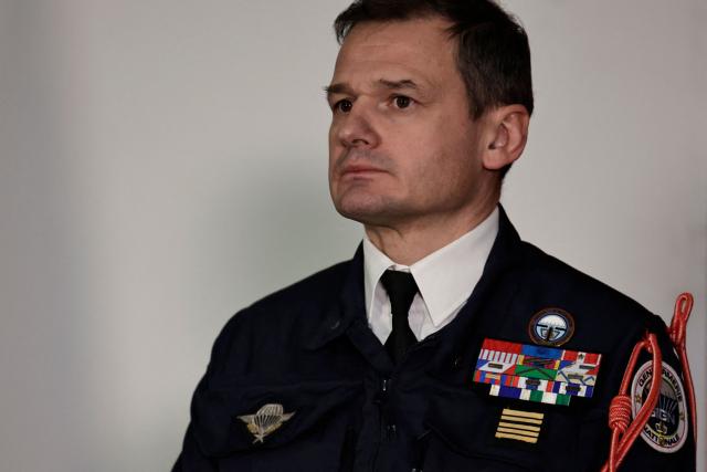 New commander of the National Gendarmerie Intervention Group (GIGN) Colonel Benoit Villeminoz listens to the speech of France's Minister of the Interior during a ceremony to officially take command in Versailles, west of Paris on December 12, 2025. (Photo by STEPHANE DE SAKUTIN / AFP)