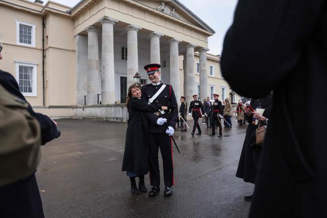 An officer cadet (C) receives a congratulatory hug as he takes part in the No. 251 Sovereign’s Parade ceremonies at the Royal Military Academy in Sandhurst, southwest of London on December 12, 2025. The parade marks the completion of 44 weeks of intensive training for the Officer Cadets of Commissioning Course 251. (Photo by Adrian DENNIS / AFP)