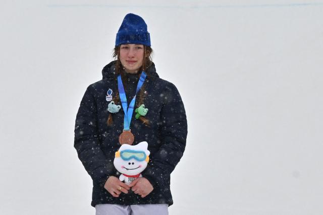 (FILES) Bronze medallist France's Lea Casta poses for photos in the awards ceremony after the women's snowboard cross final during the Gangwon 2024 Winter Youth Olympic Games at Welli Hilli Park Ski Resort in Hoengseong on January 20, 2024. At 19, she’s starting the snowboard cross season as a top dog on the circuit. But Lйa Casta, winner of the big crystal globe in 2025, says she still has “a lot to learn” before the Olympics in February, in which she dreams of attending first and foremost to “discover. (Photo by Jung Yeon-je / AFP)