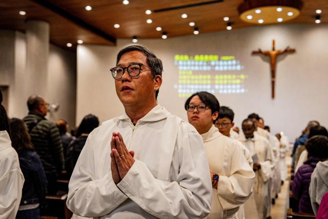 Clergy members leave after attending a Mass at the St. Benedict's Church in Hong Kong on December 12, 2025, for the victims of a deadly fire at the Wang Fuk Court residential estate in the Tai Po district. (Photo by Leung Man Hei / AFP)