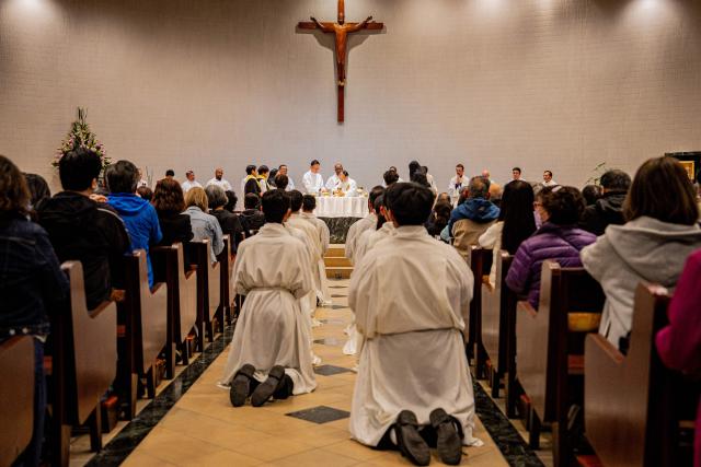 Clergy members pray during a Mass at the St. Benedict's Church in Hong Kong on December 12, 2025, for the victims of a deadly fire at the Wang Fuk Court residential estate in the Tai Po district. (Photo by Leung Man Hei / AFP)
