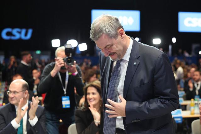 Bavaria's State Premier and leader of the conservative Christian Social Union (CSU) Markus Soeder is applauded by the audience as he arrives to a congress of the Christian Social Union (CSU) party on December 12, 2025 in Munich, southern Germany. (Photo by Alexandra BEIER / AFP)
