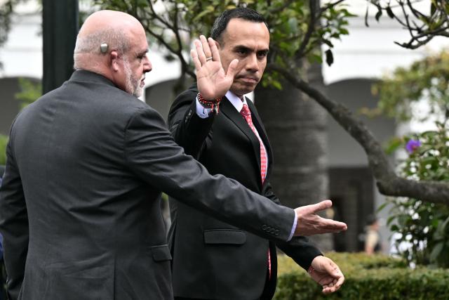 Peru's President Jose Jeri waves after laying a wreath at the Plaza Grande in Quito, on December 12, 2025, during a visit to strengthen cooperation between the countries. (Photo by Rodrigo BUENDIA / AFP)