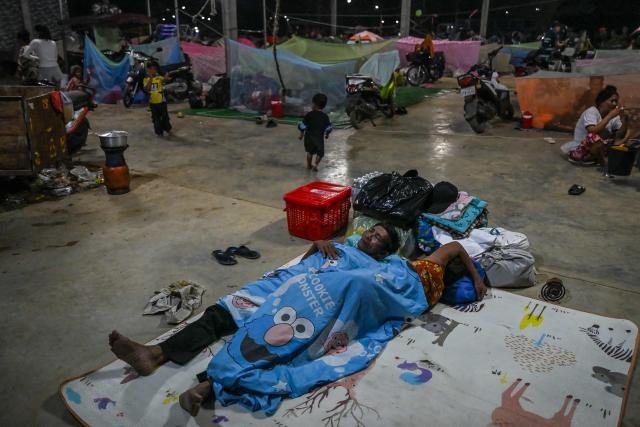 Displaced residents rest at a temporary camp in Banteay Meanchey province on December 12, 2025, amid clashes along the Cambodia-Thailand border. (Photo by TANG CHHIN Sothy / AFP)