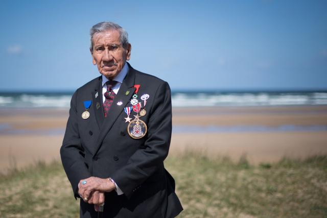 (FILES) World War II veteran Charles Norman Shay, a Penobscot Native American, who took part in the Operation Overlord (Battle of Normandy) during the D-Day on June 6, 1944, poses on May 4, 2019 in Omaha Beach, western France. The funeral of Charles Norman Shay, who died at the age of 101 on December 3 and was presented as the last Native American survivor of the June 6, 1944 landings, took place December 12, 2025, morning at Bayeux Cathedral, according to the diocese. (Photo by LOIC VENANCE / AFP)