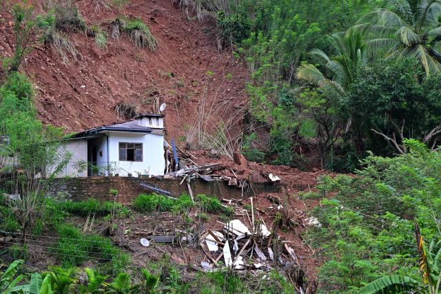 A house lies in a shattered state following landslides in the aftermath of Cyclone Ditwah, in Badulla on December 12, 2025. Two tropical storms dumped massive amounts of rain on the countries last month, prompting landslides and flooding that killed more than 600 people in Sri Lanka and nearly 1,000 in Indonesia. (Photo by Ishara S. KODIKARA / AFP)