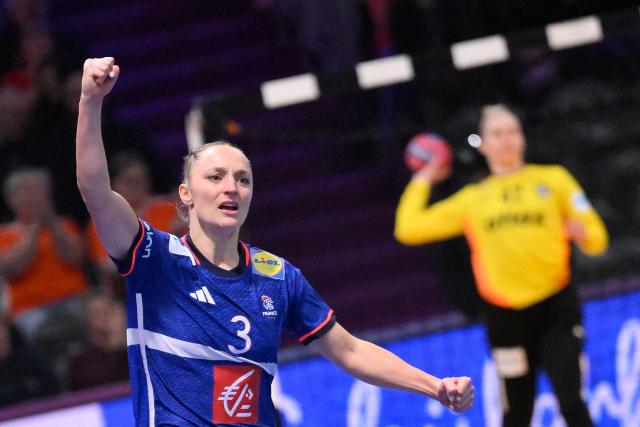 France's right winger #03 Alicia Toublanc (L) celebrates after scoring during the IHF Women's Handball World Championship semi final match between France and Germany in Rotterdam Ahoy Arena, in Rotterdam, on December 12, 2025. (Photo by JOHN THYS / AFP)