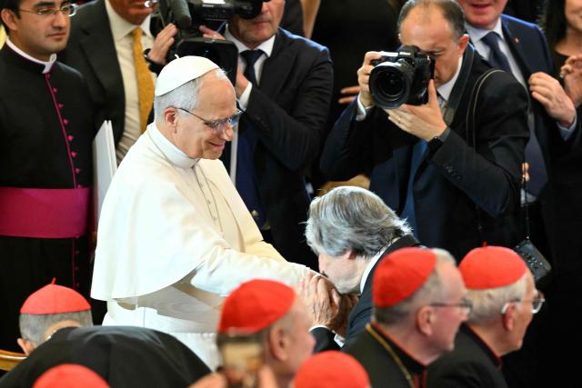 Conductor Riccardo Muti kisses the hand of Pope Leo XIV as he receives the Ratzinger Prize 2025 during a Christmas concert, at Paul-VI audience hall in The Vatican on December 12, 2025. (Photo by Tiziana FABI / AFP)