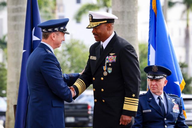 US Air Force Gen. Dan Caine, chairman of the Joint Chiefs of Staff (L), shakes hands with US Navy Adm. Alvin Holsey (R) during Holsey’s relinquishment of command and retirement ceremony at US Southern Command (SOUTHCOM) headquarters in Doral, Florida, on December 12, 2025. The US admiral responsible for overseeing a major military buildup in the Caribbean and controversial strikes on alleged drug-smuggling boats stepped down on Friday just a year into his tenure. (Photo by Eva Marie UZCATEGUI / AFP)