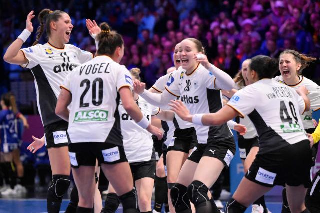 Germany's players celebrate their victory and progressing to the final at the end of the IHF Women's Handball World Championship semi final match between France and Germany in Rotterdam Ahoy Arena, in Rotterdam, on December 12, 2025. (Photo by JOHN THYS / AFP)