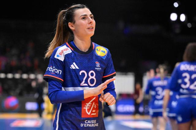 France's right winger #28 Lucie Granier reacts at the end of the IHF Women's Handball World Championship semi final match between France and Germany in Rotterdam Ahoy Arena, in Rotterdam, on December 12, 2025. (Photo by JOHN THYS / AFP)