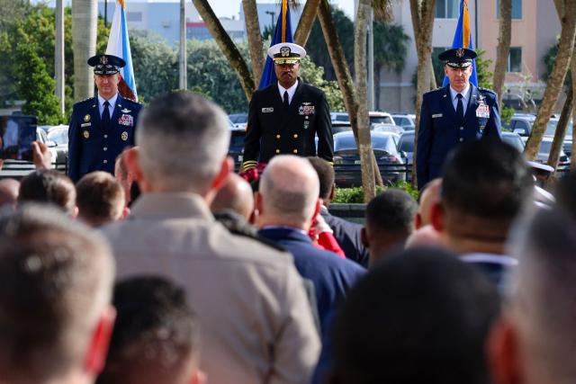 US Air Force Gen. Dan Caine, chairman of the Joint Chiefs of Staff (L), US Navy Adm. Alvin Holsey (C), outgoing commander of US Southern Command, and US Air Force Lt. Gen. Evan L. Pettus (R) stand together during Holseys relinquishment of command and retirement ceremony at US Southern Command (SOUTHCOM) headquarters in Doral, Florida, on December 12, 2025. The US admiral responsible for overseeing a major military buildup in the Caribbean and controversial strikes on alleged drug-smuggling boats stepped down on Friday just a year into his tenure. (Photo by Eva Marie UZCATEGUI / AFP)
