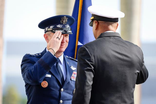 S Air Force Gen. Dan Caine (L), chairman of the Joint Chiefs of Staff, salutes US Navy Adm. Alvin Holsey (R) during his relinquishment of command and retirement ceremony at US Southern Command (SOUTHCOM) headquarters in Doral, Florida, on December 12, 2025. The US admiral responsible for overseeing a major military buildup in the Caribbean and controversial strikes on alleged drug-smuggling boats stepped down on Friday just a year into his tenure. (Photo by Eva Marie UZCATEGUI / AFP)