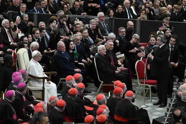 Conductor Riccardo Muti (R) speaks in front of Pope Leo XIV as he receives the Ratzinger Prize 2025 during a Christmas concert, at Paul-VI audience hall in The Vatican on December 12, 2025. (Photo by Tiziana FABI / AFP)