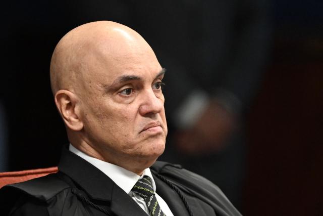 (FILES) Brazil's Federal Supreme Court (STF) minister Alexandre de Moraes gestures during the voting session to convict or acquit far-right former president Jair Bolsonaro (2019-2022) in a coup trial at the Federal Supreme Court in Brasilia on September 10, 2025. The US Treasury Department lifted sanctions on December 12, 2025 on de Moraes, who oversaw a trial of his country's former president Jair Bolsonaro and was sanctioned in July was originally sanctioned in July, followed by measures against his wife, Viviane Barci de Moraes. Both sanctions have since been eased, as the countries move to repair tense relations. (Photo by Evaristo Sa / AFP)