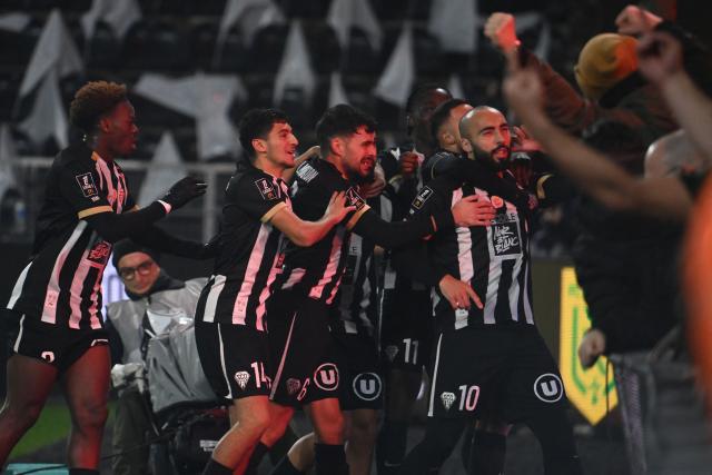 Angers' Algerian midfielder #10 Himad Abdelli (R) celebrates with teammates scoring his team's first goal during the French L1 football match between SCO Angers and FC Nantes at the Raymond-Kopa Stadium in Angers, western France, on December 12, 2025. (Photo by JEAN-FRANCOIS MONIER / AFP)