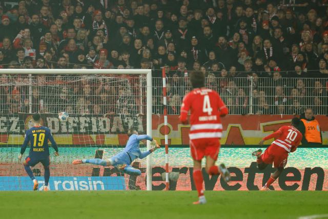 Union Berlin's German forward #10 Ilyas Ansah scores his team's second goal 2:1 during the German first division Bundesliga football match between 1 FC Union Berlin and RB Leipzig in Berlin on December 12, 2025. (Photo by Odd ANDERSEN / AFP) / DFL REGULATIONS PROHIBIT ANY USE OF PHOTOGRAPHS AS IMAGE SEQUENCES AND/OR QUASI-VIDEO