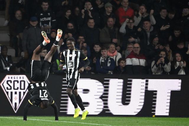 Angers' Cameroonian forward #31 Djibirin Harouna (R) and Angers' French defender #27 Lilian Raolisoa (L) celebrate their team's fourth goal during the French L1 football match between SCO Angers and FC Nantes at the Raymond-Kopa Stadium in Angers, western France, on December 12, 2025. (Photo by JEAN-FRANCOIS MONIER / AFP)