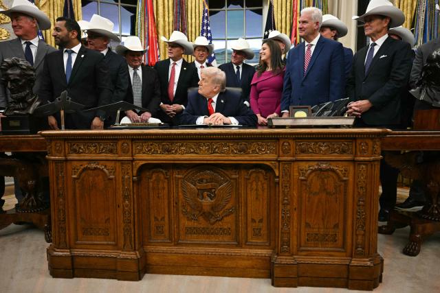 US President Donald Trump speaks during a bill signing ceremony with members of the 1980 US Olympic men's ice hockey team in the Oval Office of the White House in Washington, DC, on December 12, 2025. The legislation will award all of the players with Congressional Gold Medals to recognize the 45th anniversary of the US victory at the 1980 Winter Olympic Games. (Photo by Jim WATSON / AFP)