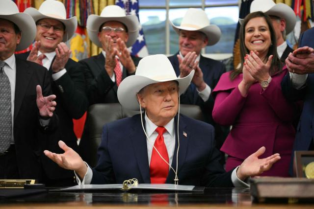 US President Donald Trump wears a cowboy hat during a bill signing ceremony with members of the 1980 US Olympic men's ice hockey team in the Oval Office of the White House in Washington, DC, on December 12, 2025. The legislation will award all of the players with Congressional Gold Medals to recognize the 45th anniversary of the US victory at the 1980 Winter Olympic Games. (Photo by Jim WATSON / AFP)