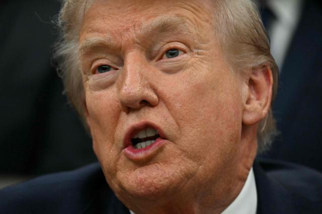 US President Donald Trump speaks during a bill signing ceremony with members of the 1980 US Olympic men's ice hockey team in the Oval Office of the White House in Washington, DC, on December 12, 2025. The legislation will award all of the players with Congressional Gold Medals to recognize the 45th anniversary of the US victory at the 1980 Winter Olympic Games. (Photo by Jim WATSON / AFP)