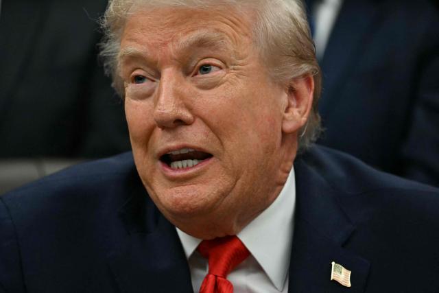 US President Donald Trump speaks during a bill signing ceremony with members of the 1980 US Olympic men's ice hockey team in the Oval Office of the White House in Washington, DC, on December 12, 2025. The legislation will award all of the players with Congressional Gold Medals to recognize the 45th anniversary of the US victory at the 1980 Winter Olympic Games. (Photo by Jim WATSON / AFP)